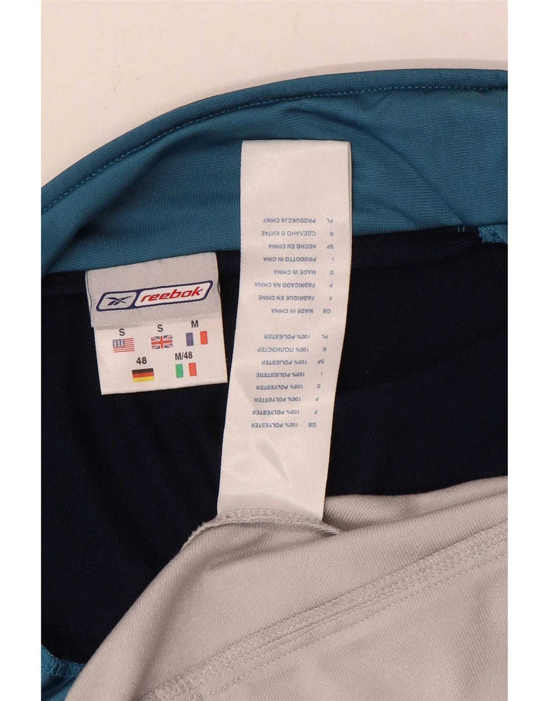 Męska kurtka dresowa Reebok o luźnym kroju, mała, biała, z blokami kolorów