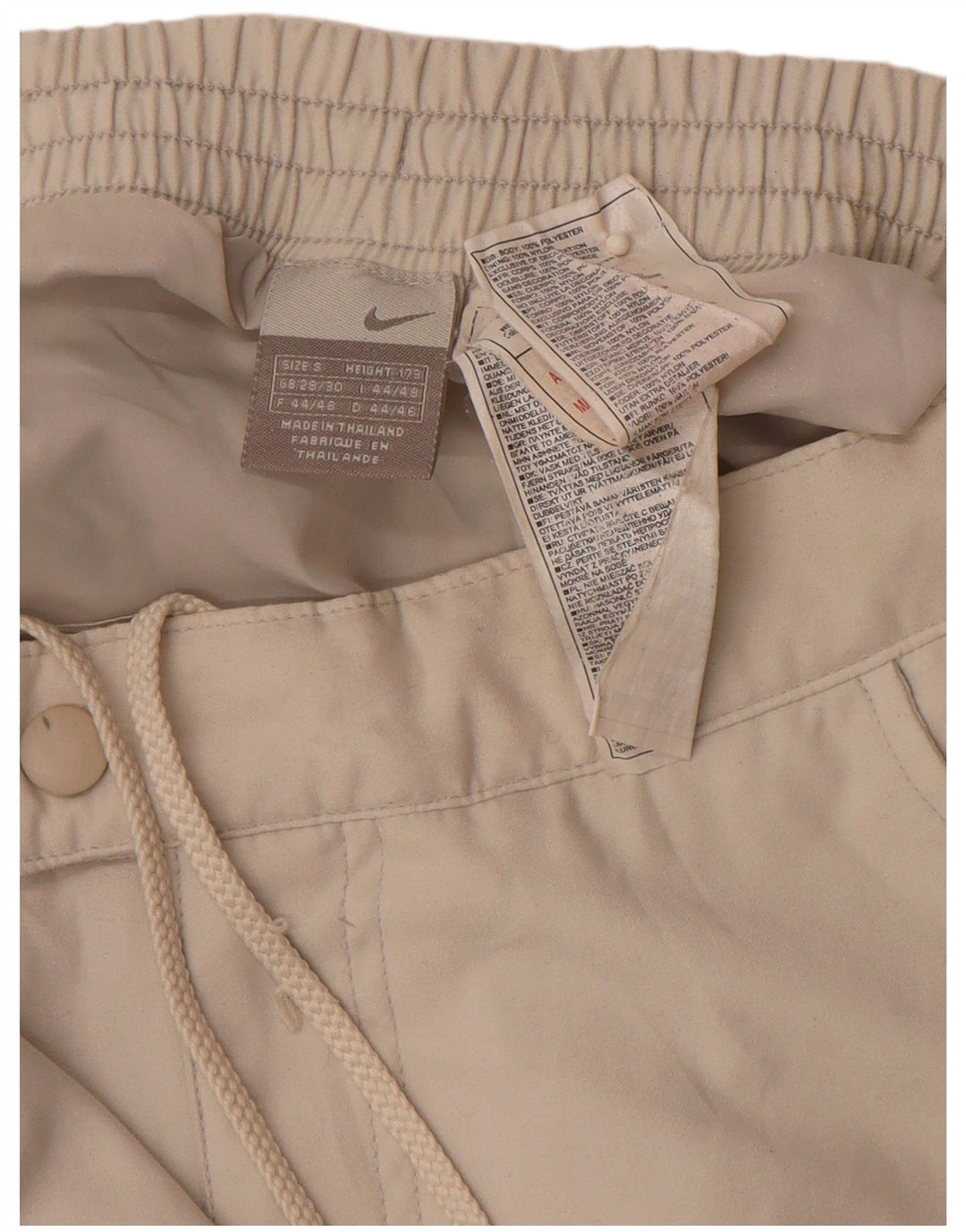 Męskie proste spodnie wiatrówkowe NIKE małe W29 L30 w kolorze beżowym