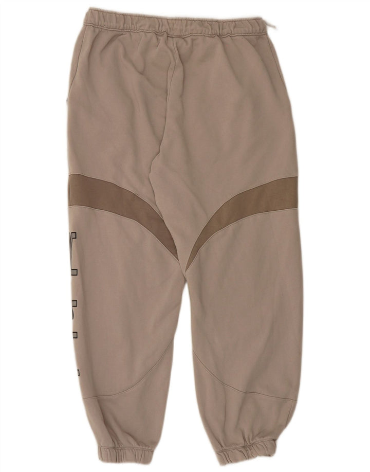 Męskie spodnie dresowe Nike Graphic Joggers w kolorze średniego beżu