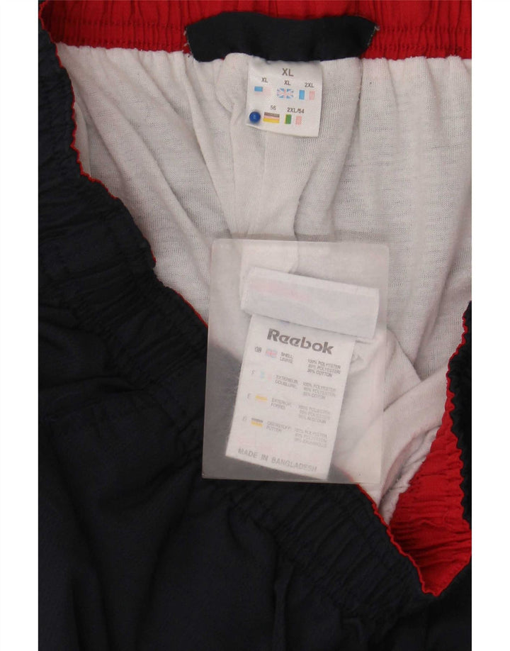 Męskie spodnie dresowe Adidas Capri XL granatowe, poliestrowe