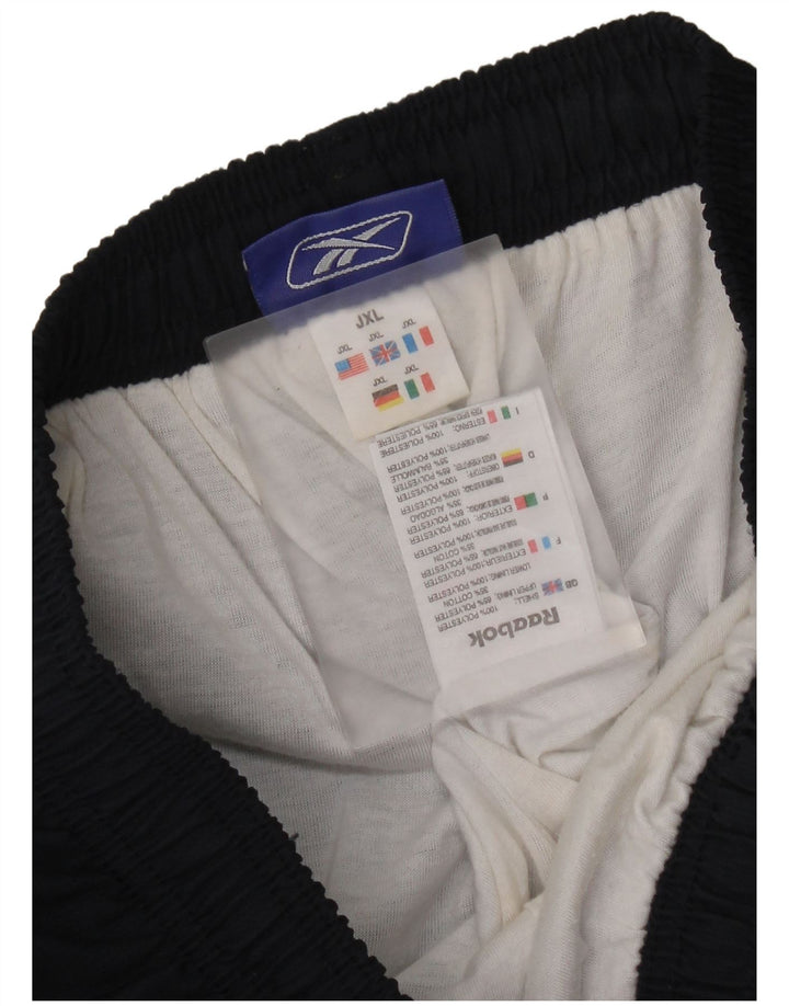 Chłopięce spodnie dresowe Reebok z grafiką 14-15 lat XL, granatowe, z blokami kolorów